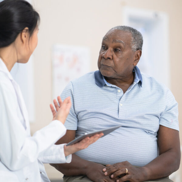 older gentleman discussing weight loss options with medical professional